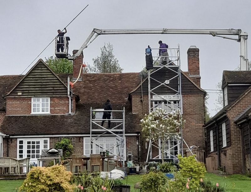 The Moss Cleaners using cherry picker and scaffolding to clean roof safely and professionally in Fleet, Hampshire